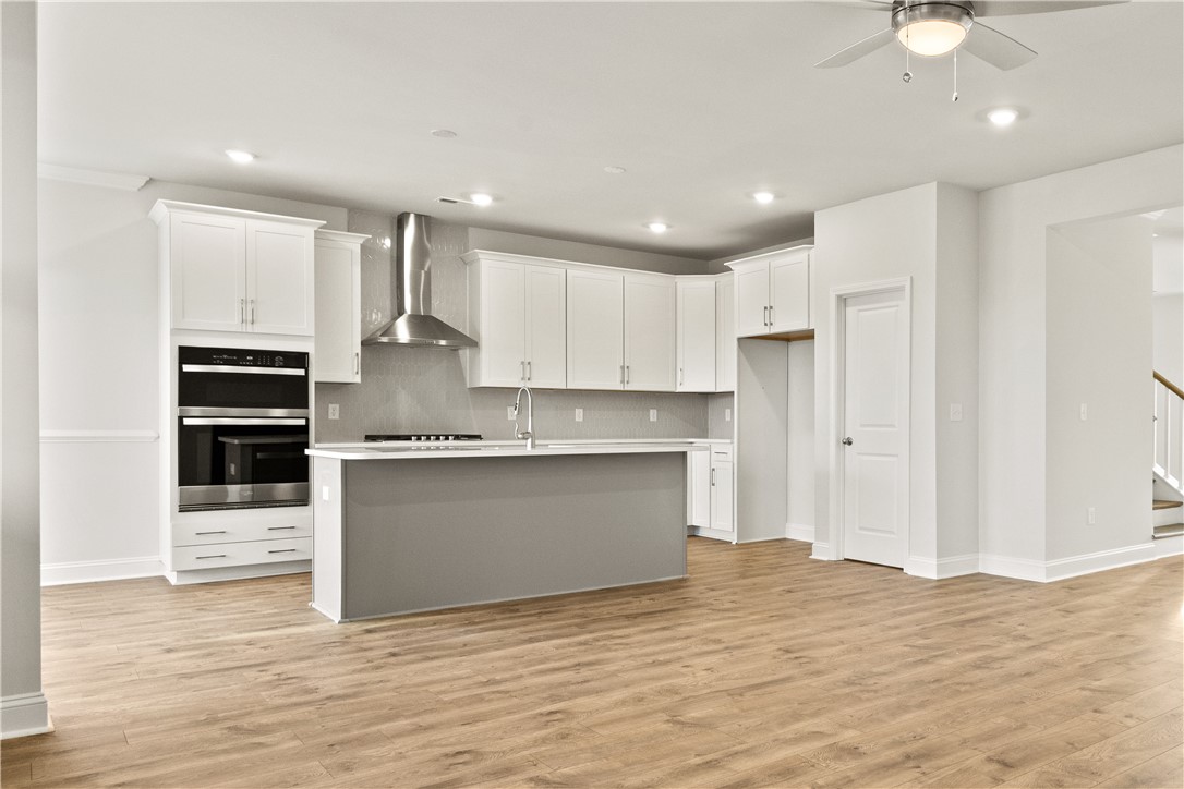 134 Anderson Oaks Lane, Unit 84 Easley, SC 29642 - Photo 12 of 43 This open-concept kitchen features a spacious island and modern appliances, ideal for culinary endeavors.