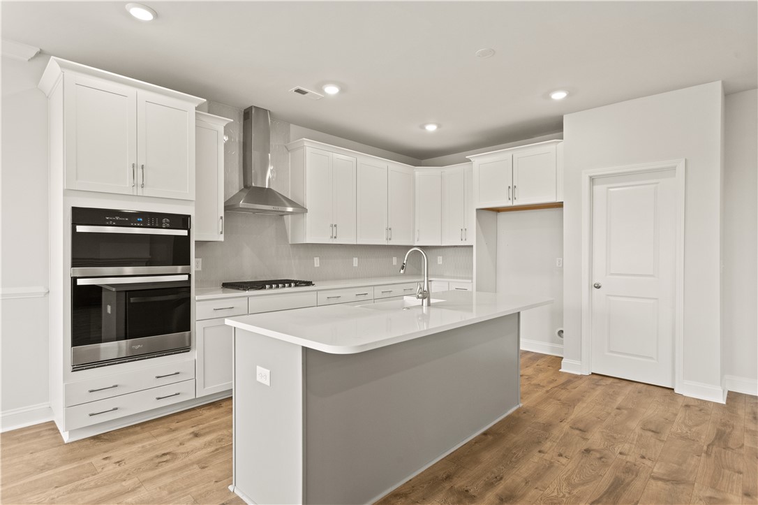 134 Anderson Oaks Lane, Unit 84 Easley, SC 29642 - Photo 13 of 43 This modern kitchen features a spacious island and sleek appliances, perfect for culinary endeavors.