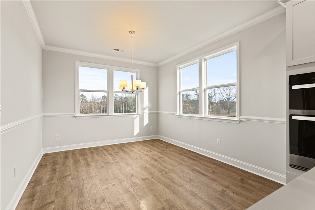 134 Anderson Oaks Lane, Unit 84 Easley, SC 29642 - Photo 15 of 43 This bright dining area features beautiful flooring, large windows, and elegant trim.