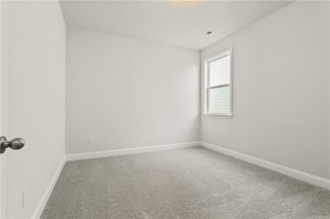 134 Anderson Oaks Lane, Unit 84 Easley, SC 29642 - Photo 18 of 43 Bright and airy room with plush carpet, perfect for a peaceful retreat.