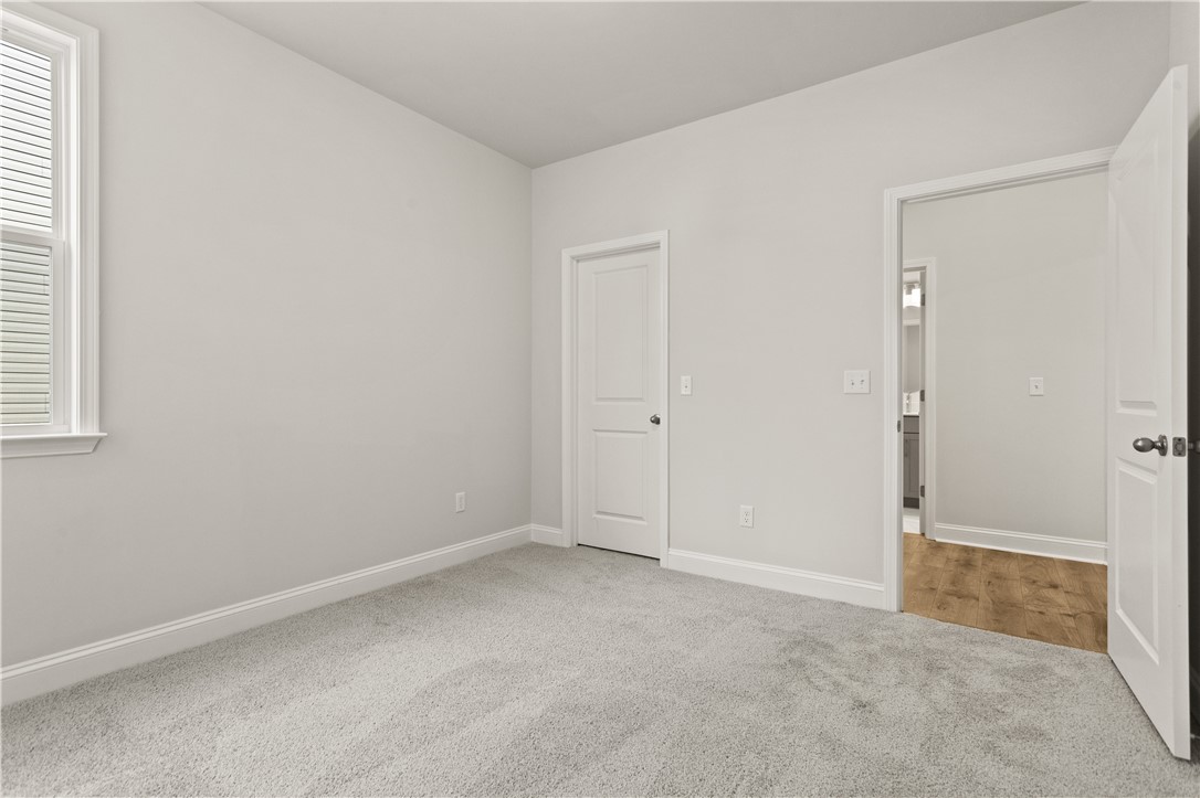 134 Anderson Oaks Lane, Unit 84 Easley, SC 29642 - Photo 19 of 43 This bright and airy room features soft carpeting and ample natural light, creating a serene personal retreat.