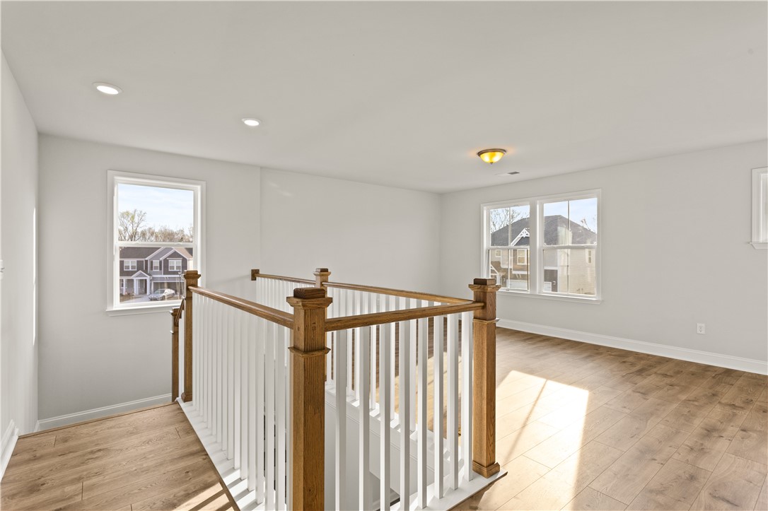 134 Anderson Oaks Lane, Unit 84 Easley, SC 29642 - Photo 20 of 43 This bright landing features wood flooring and a classic staircase, connecting living spaces seamlessly.