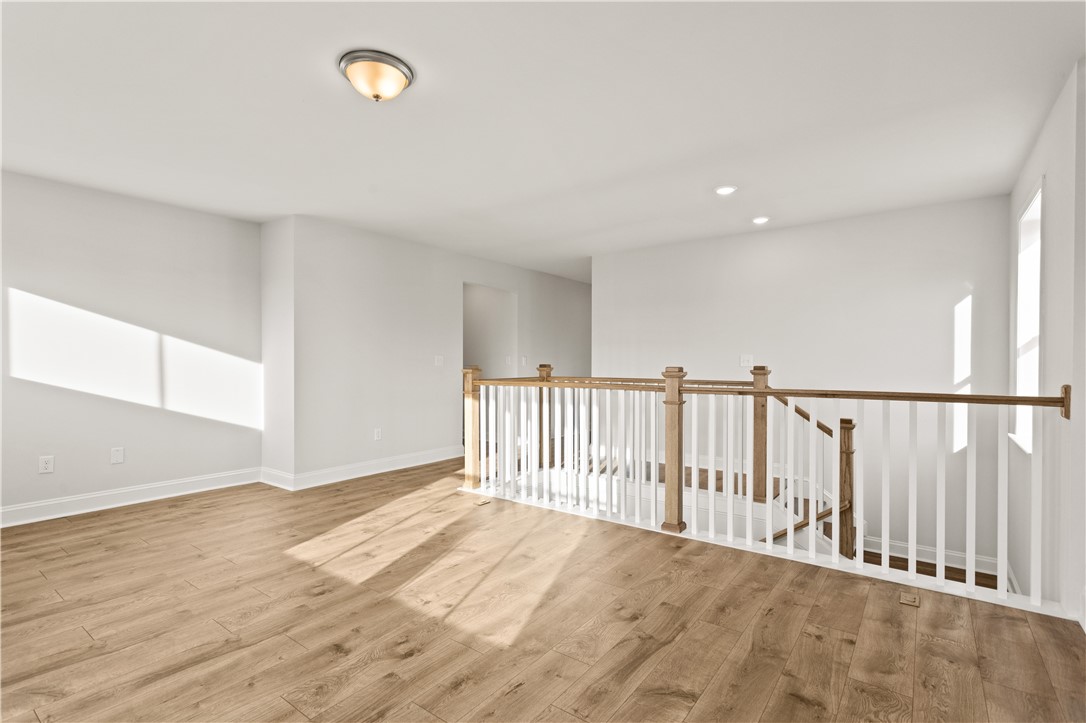 134 Anderson Oaks Lane, Unit 84 Easley, SC 29642 - Photo 21 of 43 This bright and airy space features gleaming wood floors and a charming staircase, creating an inviting atmosphere.