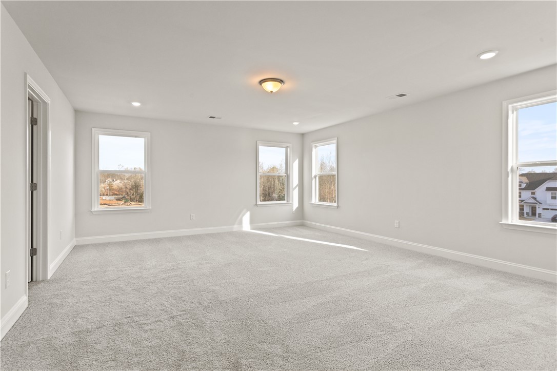 134 Anderson Oaks Lane, Unit 84 Easley, SC 29642 - Photo 22 of 43 . This expansive room offers abundant natural light, creating a bright and airy living space.