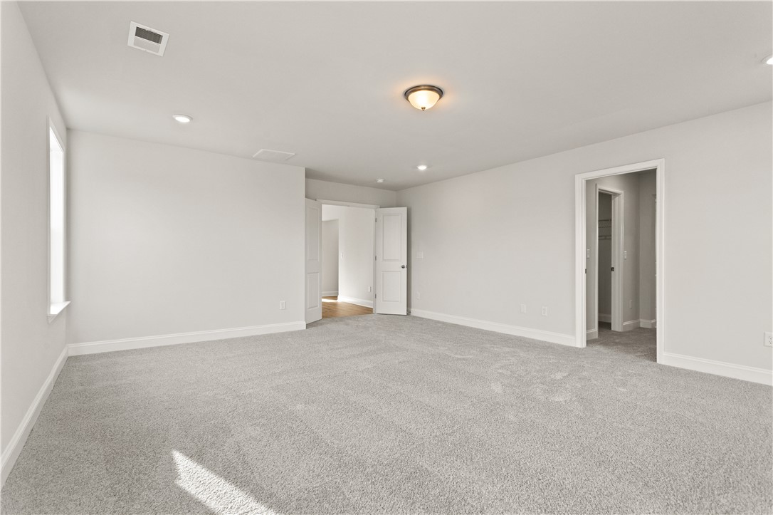 134 Anderson Oaks Lane, Unit 84 Easley, SC 29642 - Photo 23 of 43 This spacious room offers plush carpeting and natural light, perfect for comfortable living.