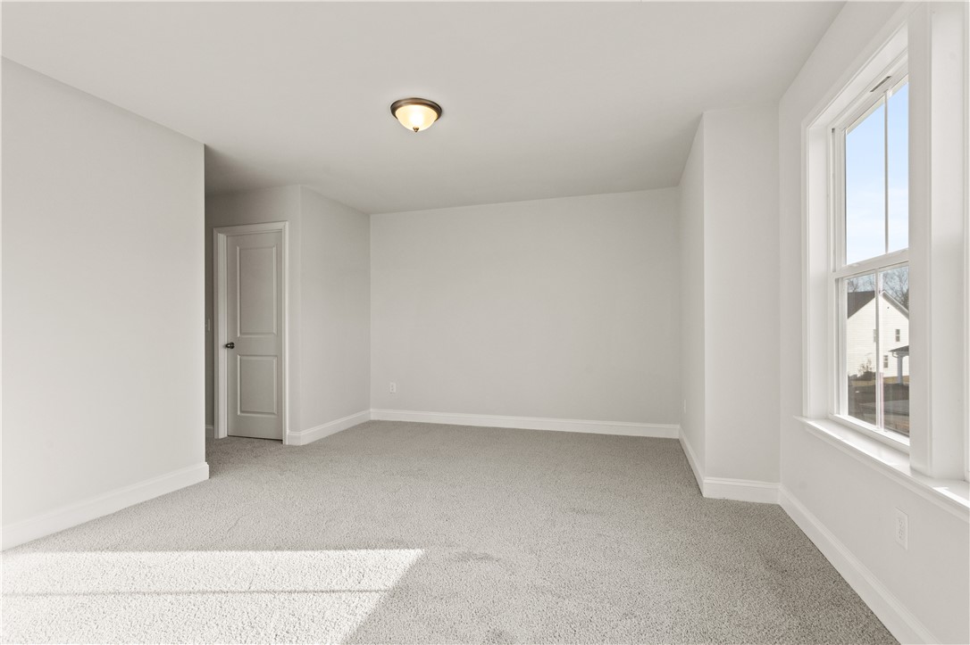 134 Anderson Oaks Lane, Unit 84 Easley, SC 29642 - Photo 28 of 43 This bright, carpeted room features a window overlooking the neighborhood and a classic ceiling light.