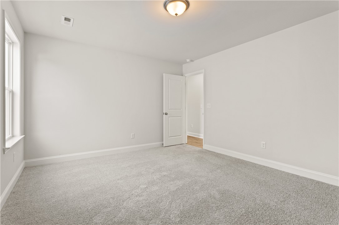 134 Anderson Oaks Lane, Unit 84 Easley, SC 29642 - Photo 30 of 43 This spacious bedroom offers a bright and airy atmosphere, ready for personal touches.