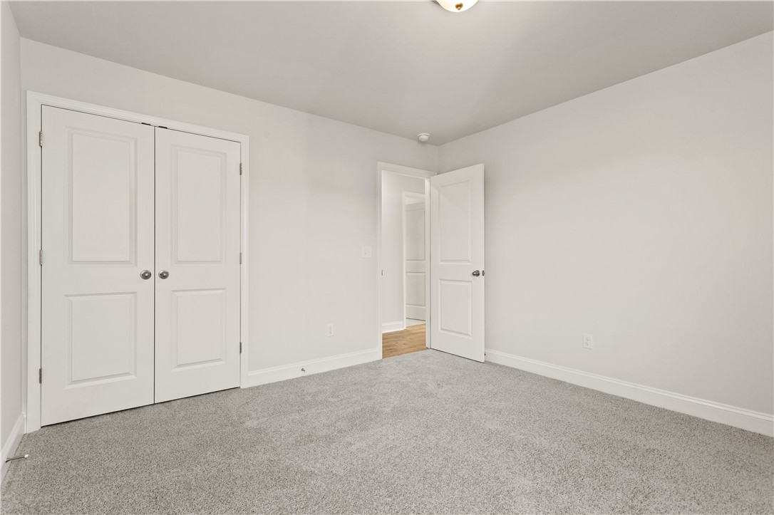 134 Anderson Oaks Lane, Unit 84 Easley, SC 29642 - Photo 32 of 43 Bright and airy room with plush carpeting and natural light, ready for personalization.
