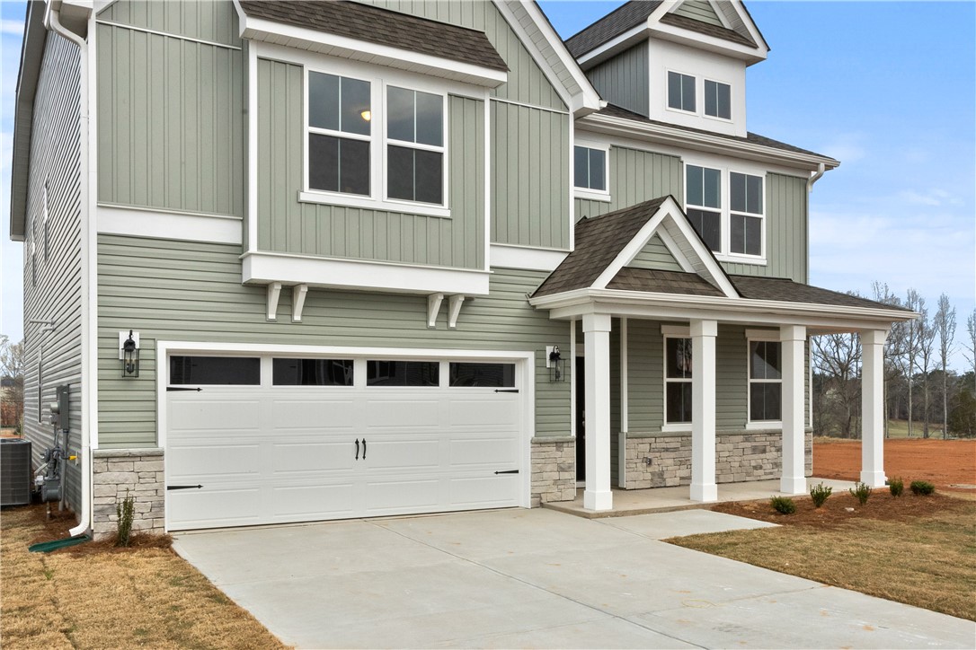 134 Anderson Oaks Lane, Unit 84 Easley, SC 29642 - Photo 4 of 43 This newly constructed home features a welcoming porch, attached garage, and charming bay windows.