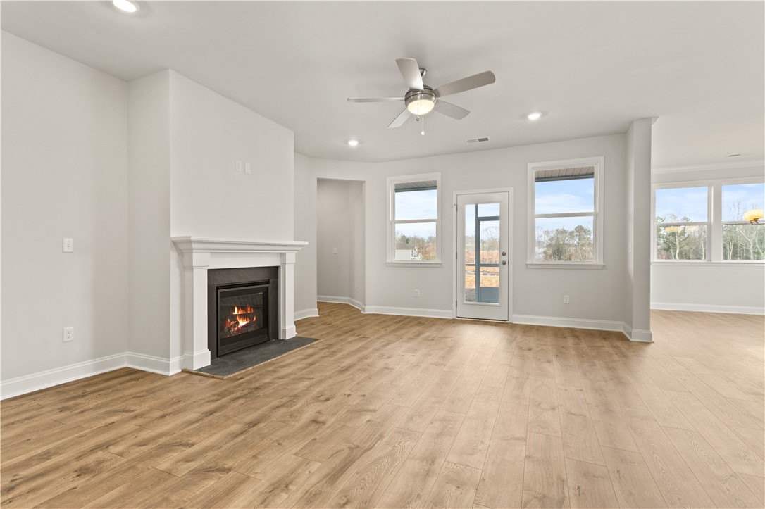 134 Anderson Oaks Lane, Unit 84 Easley, SC 29642 - Photo 9 of 43 This living area features a warm fireplace, creating a cozy and inviting atmosphere.