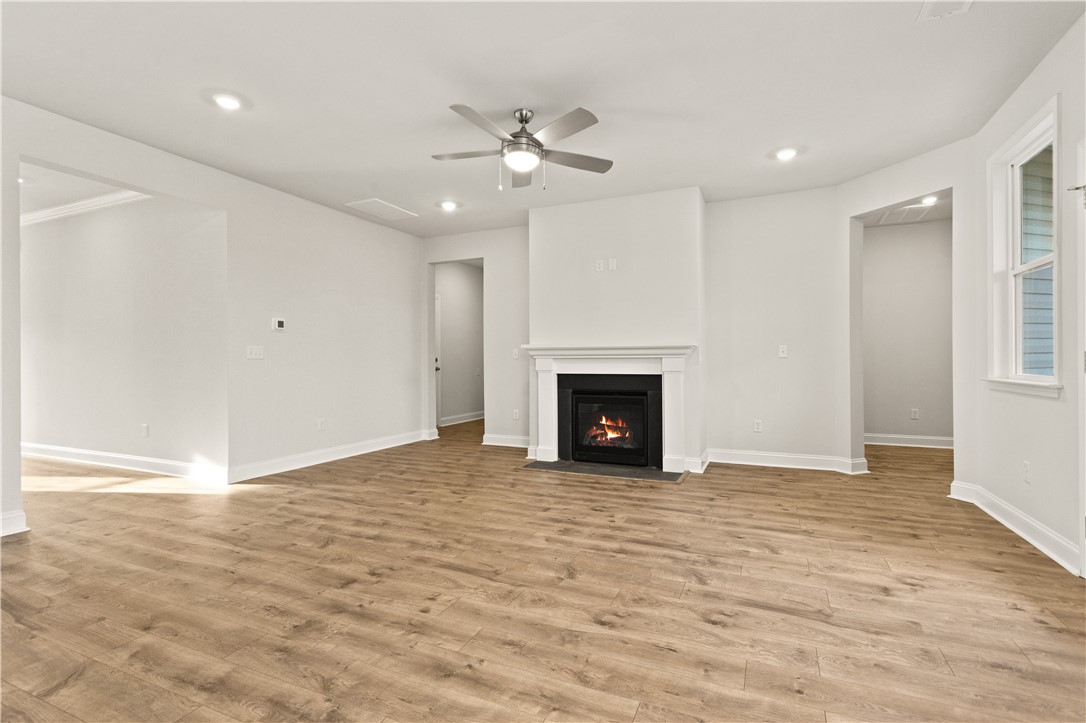 134 Anderson Oaks Lane, Unit 84 Easley, SC 29642 - Photo 10 of 43 This bright living space features warm flooring and a cozy fireplace, perfect for gathering.