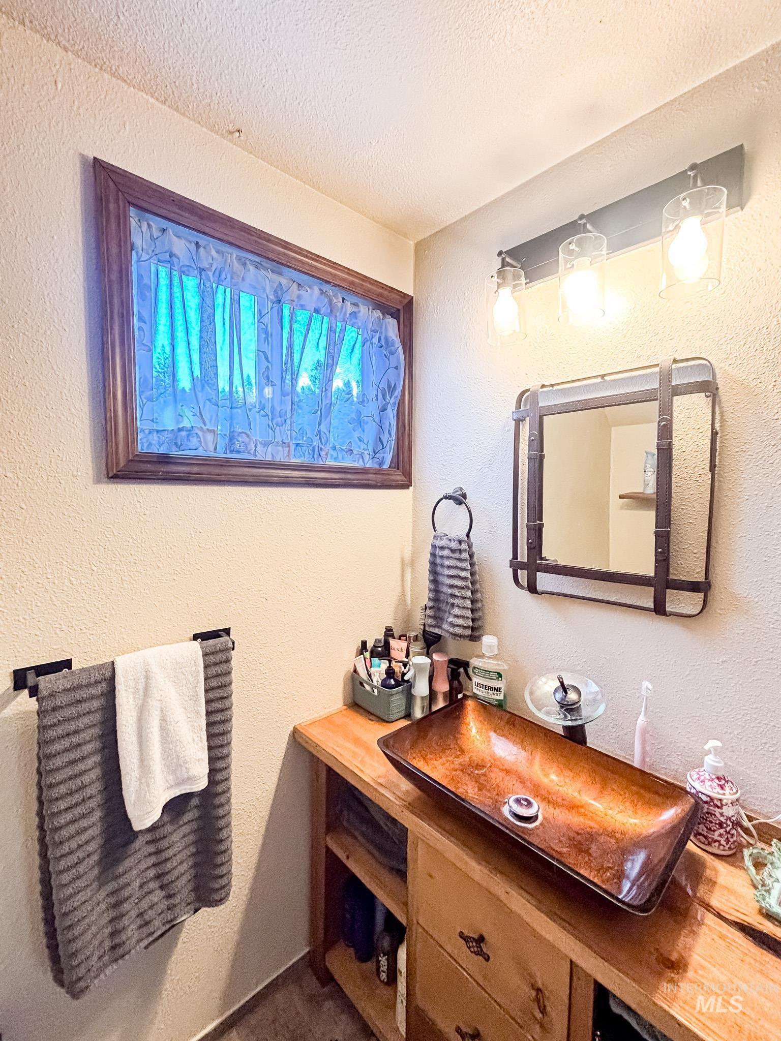 1995 Glenwood Road Kamiah, ID 83536 - Photo 22 of 38 Upper bathroom vanity featuring a wood-finish countertop