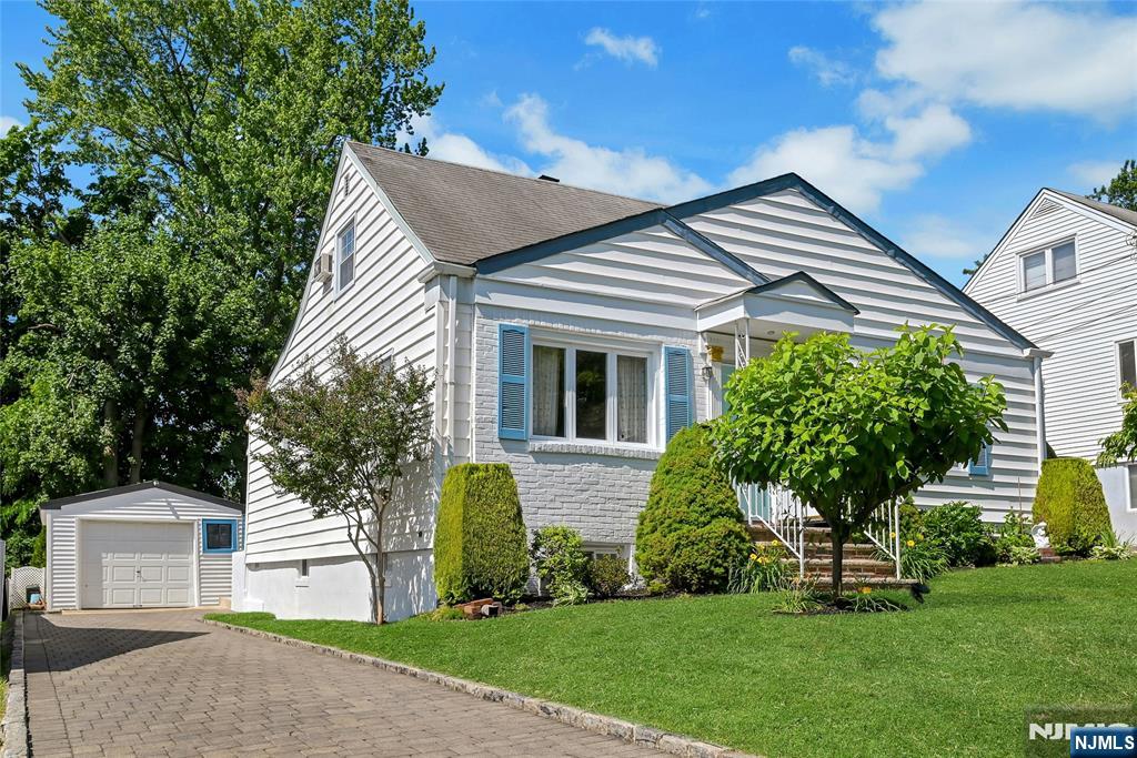 85 Edison Street Clifton, NJ 07013 - Photo 2 of 28 a front view of a house with a yard and garage