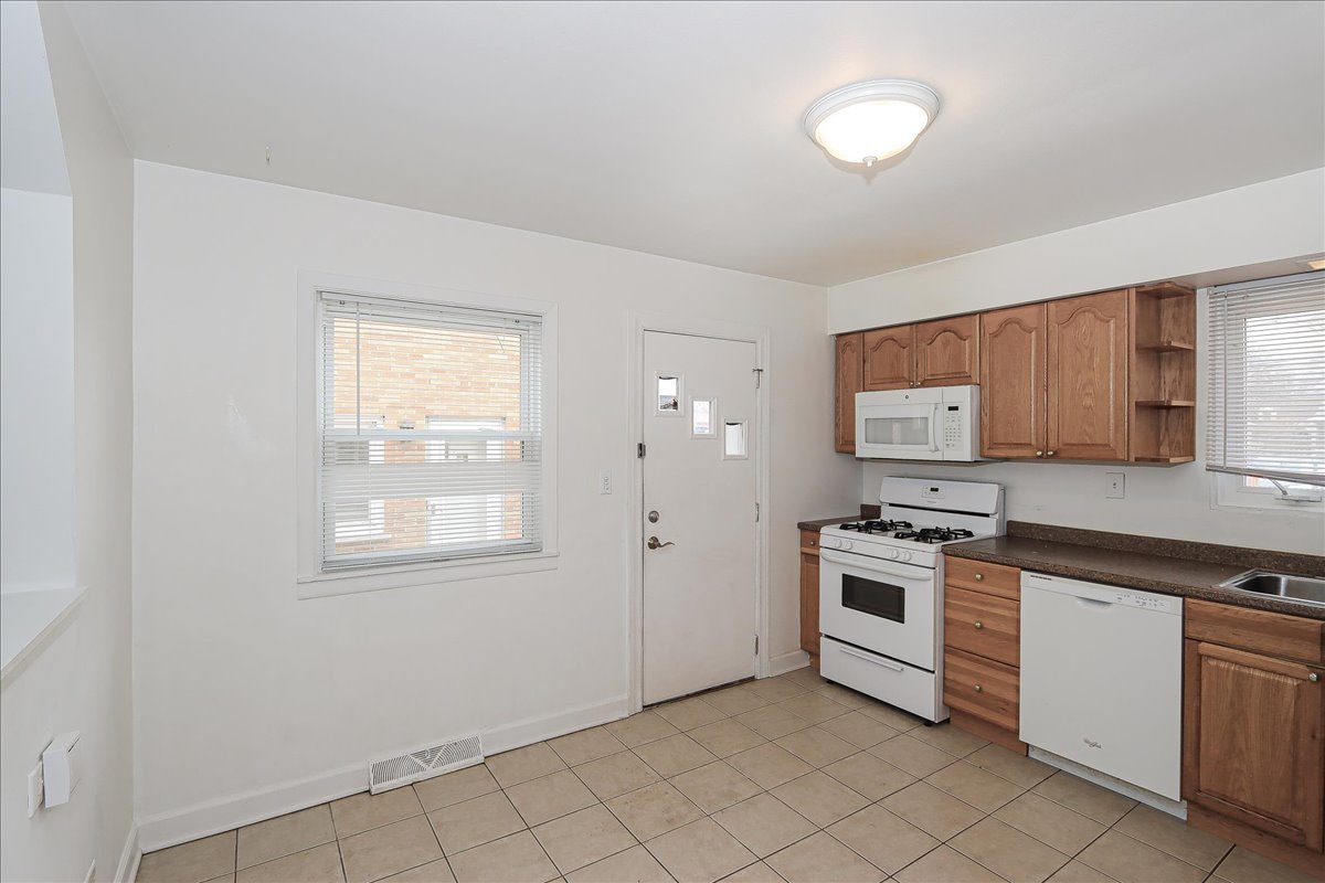 449 Elmhurst Road Mount Prospect, IL 60056 - Photo 14 of 26 a kitchen with cabinets appliances and a window