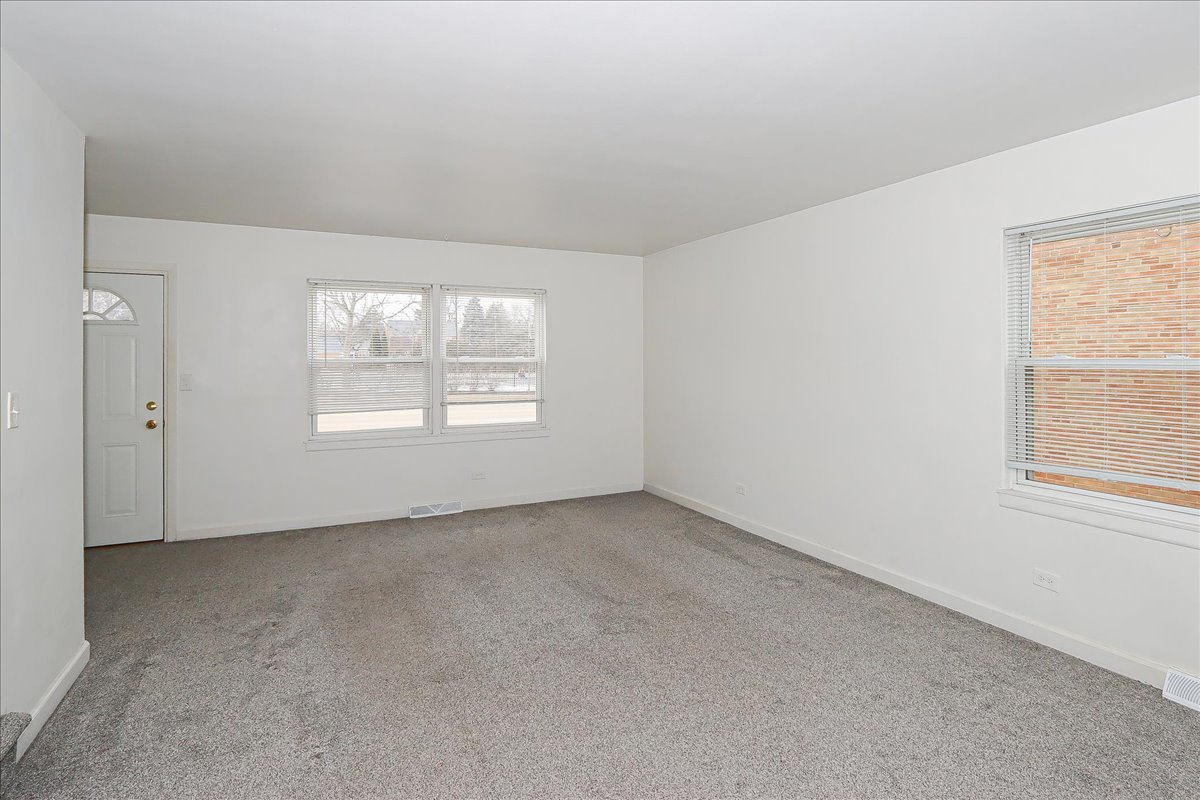 449 Elmhurst Road Mount Prospect, IL 60056 - Photo 3 of 26 an empty room with windows