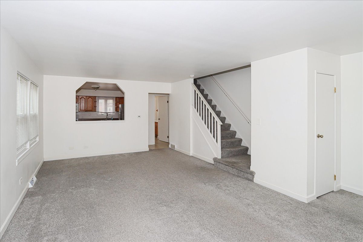 449 Elmhurst Road Mount Prospect, IL 60056 - Photo 5 of 26 a view of an empty room with a window