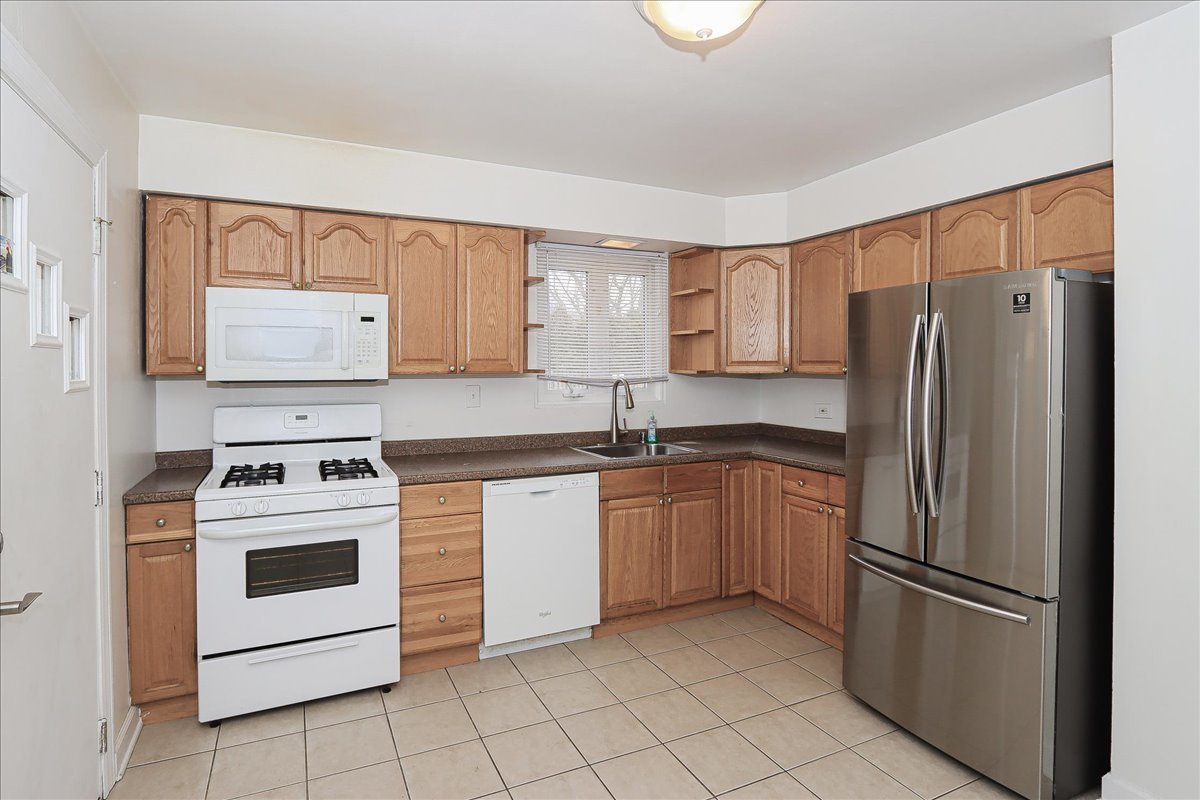 449 Elmhurst Road Mount Prospect, IL 60056 - Photo 8 of 26 a kitchen with cabinets stainless steel appliances and a counter space