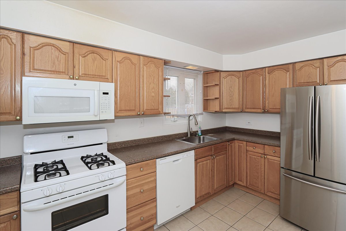 449 Elmhurst Road Mount Prospect, IL 60056 - Photo 10 of 26 a kitchen with granite countertop cabinets stainless steel appliances and a sink