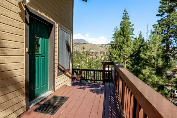 a balcony with wooden floor and outdoor seating