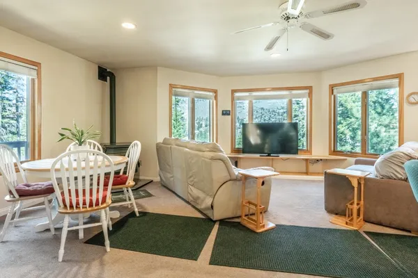 a living room with patio furniture and a floor to ceiling window