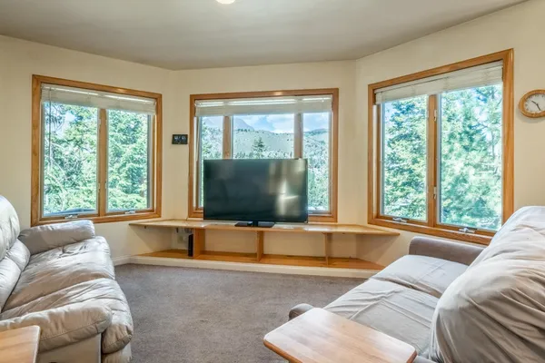 a living room with furniture and large windows