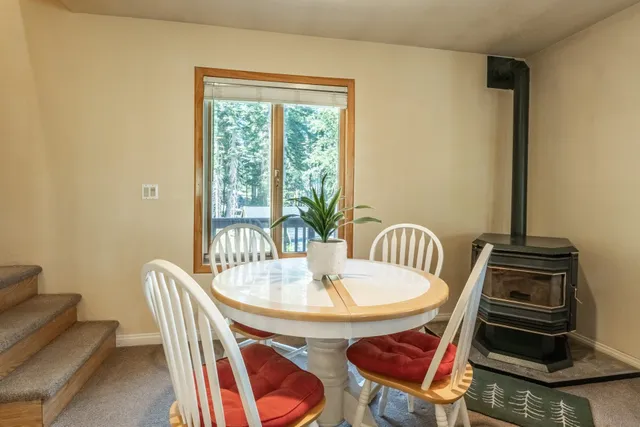 a dining room with furniture a rug and wooden floor