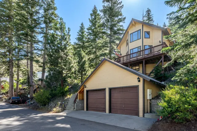 a front view of a house with a trees