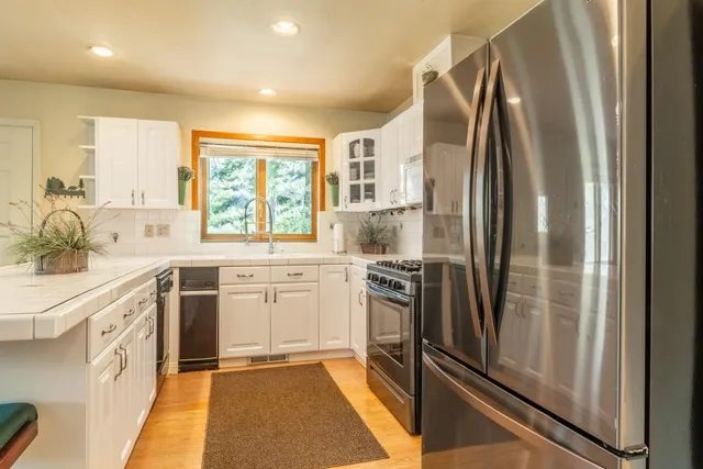 a kitchen with stainless steel appliances a refrigerator sink and stove