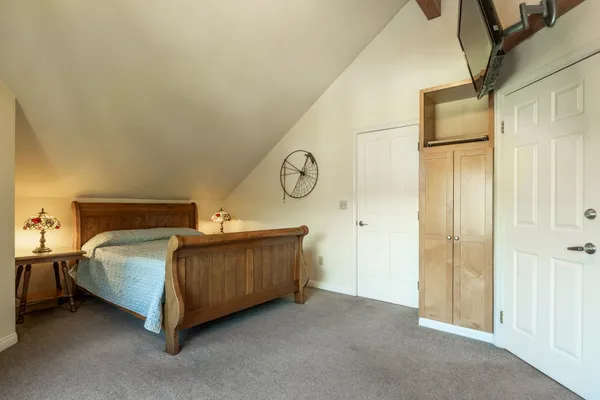 a spacious bedroom with a bed and cabinets