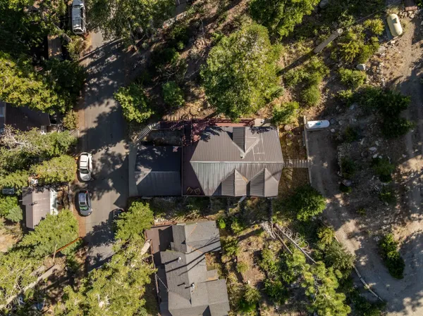 an aerial view of a house with a yard