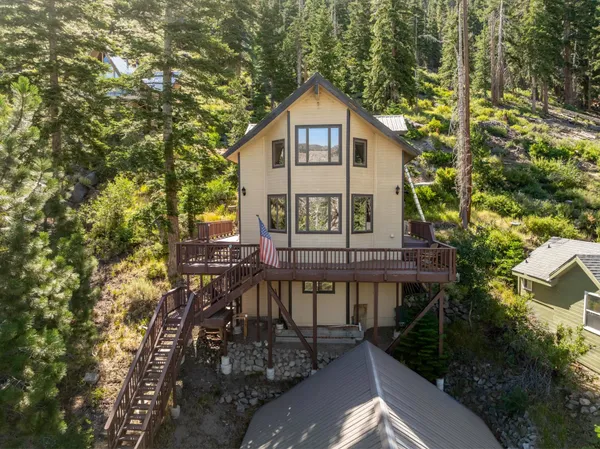a view of a house with yard and sitting area