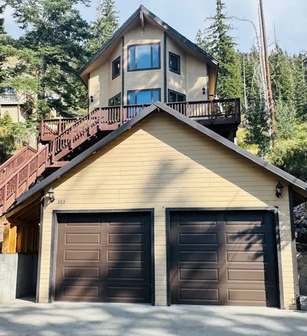 a front view of house along with trees