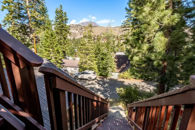 a view of balcony with wooden floor and fence