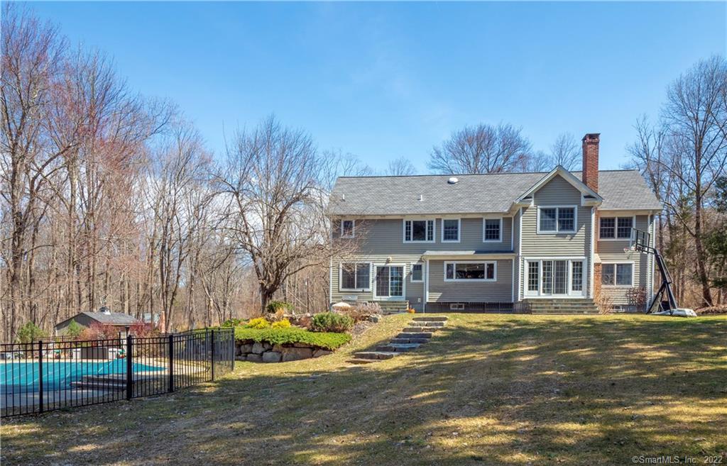 20 Deer Hill Road Redding, CT 06896 - Photo 1 of 1 a front view of a house with a garden