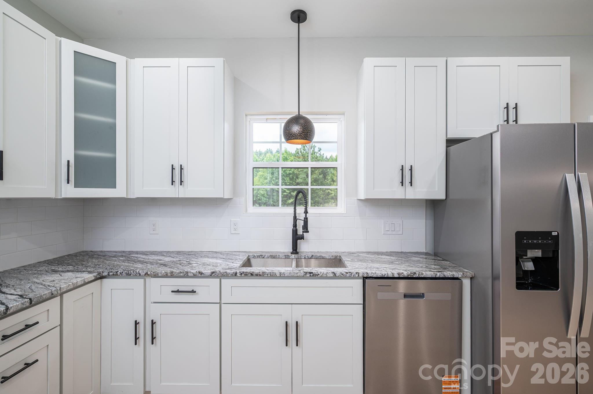 2474 Shoal Road Crouse, NC 28033 - Photo 16 of 39 a kitchen with stainless steel appliances granite countertop a refrigerator sink and cabinets