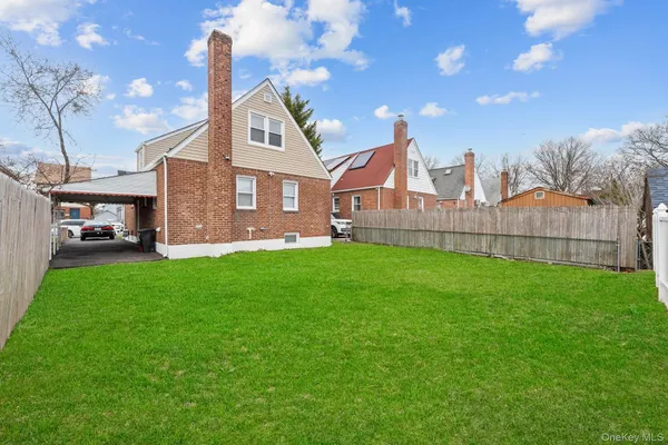 a front view of a house with a yard and table