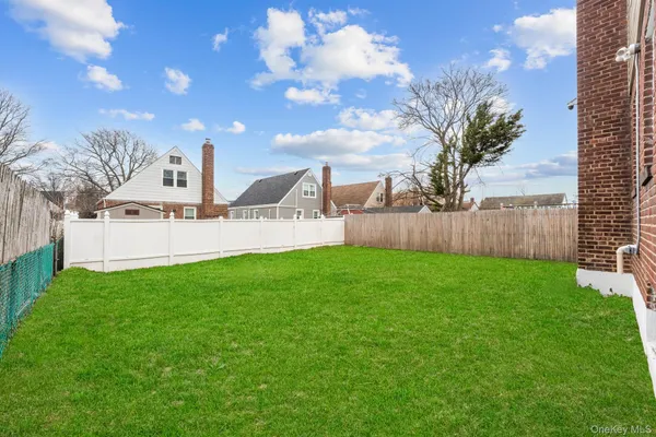 a view of a house with a backyard and a garden