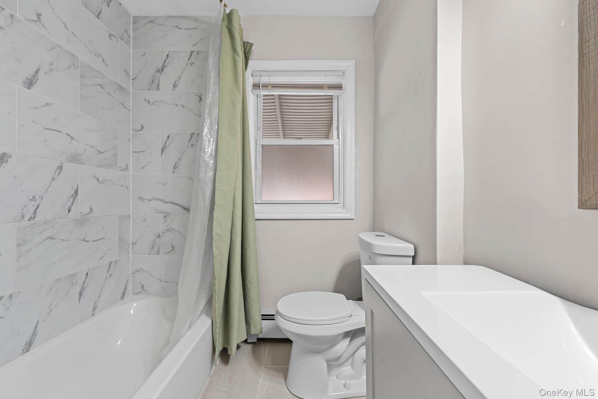 20 Dewitt Street Valley Stream, NY 11580 - Photo 5 of 13 a bathroom with a toilet and a bathtub