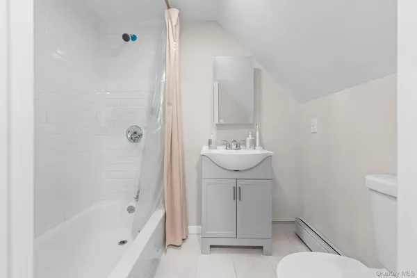 a bathroom with a sink toilet a mirror and shower
