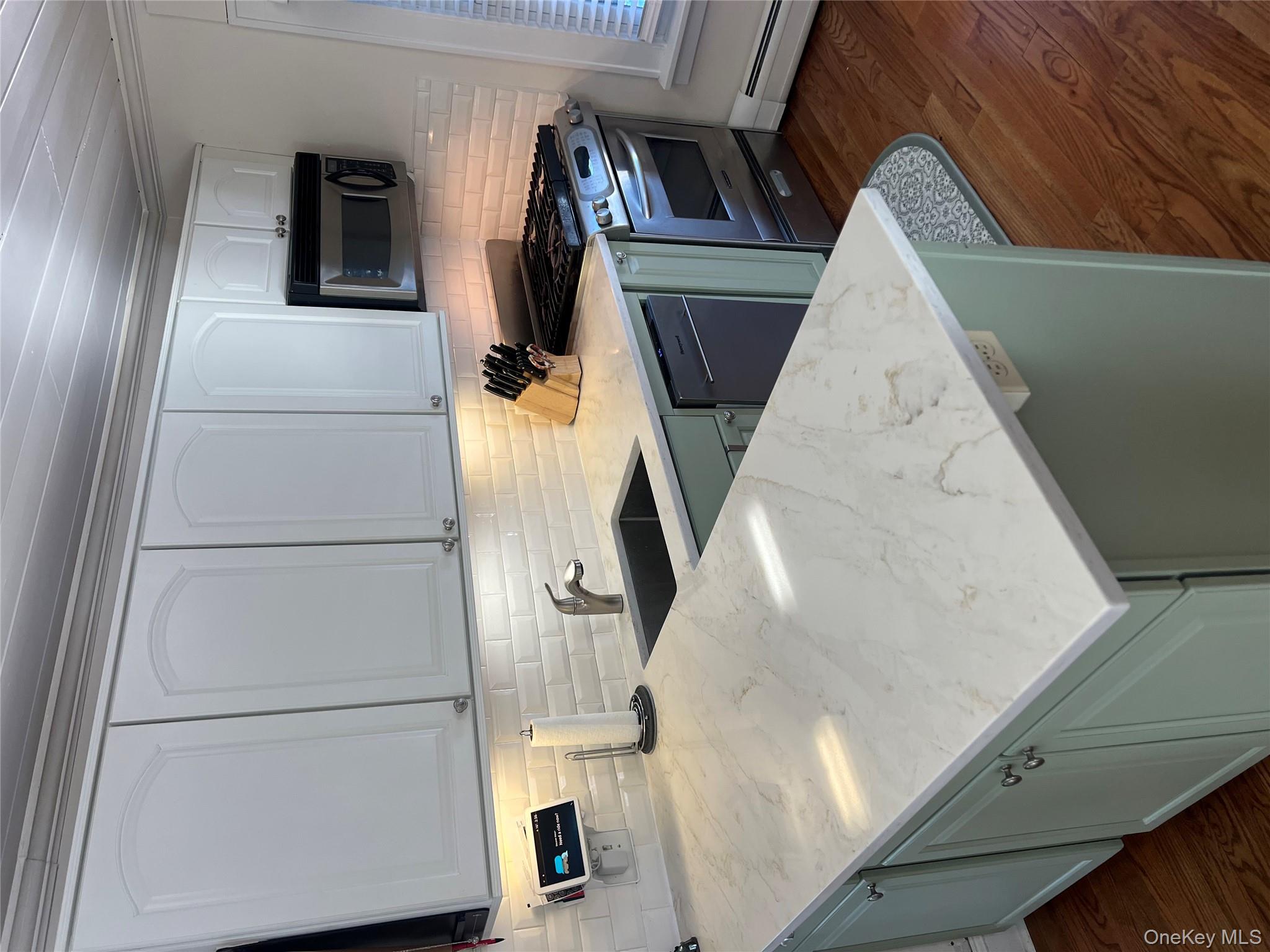 22 High Street Garnerville, NY 10923 - Photo 13 of 49 a kitchen with stainless steel appliances granite countertop a sink a stove and a microwave oven on the wooden cabinets
