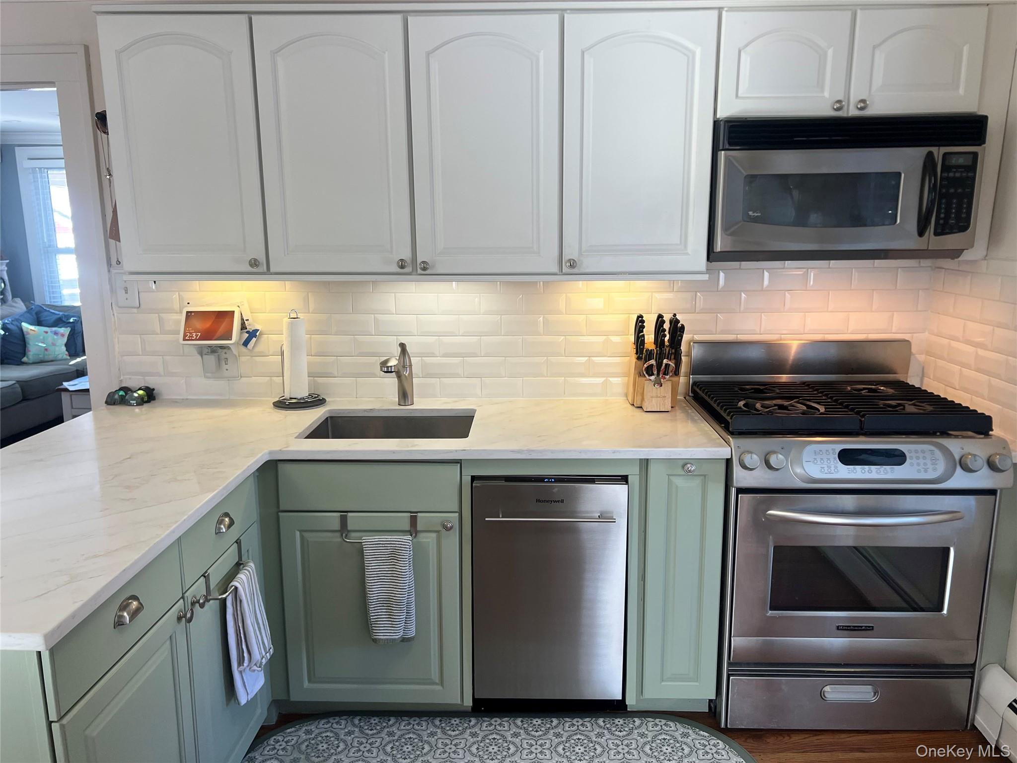 22 High Street Garnerville, NY 10923 - Photo 14 of 49 a kitchen with cabinets stainless steel appliances and a sink
