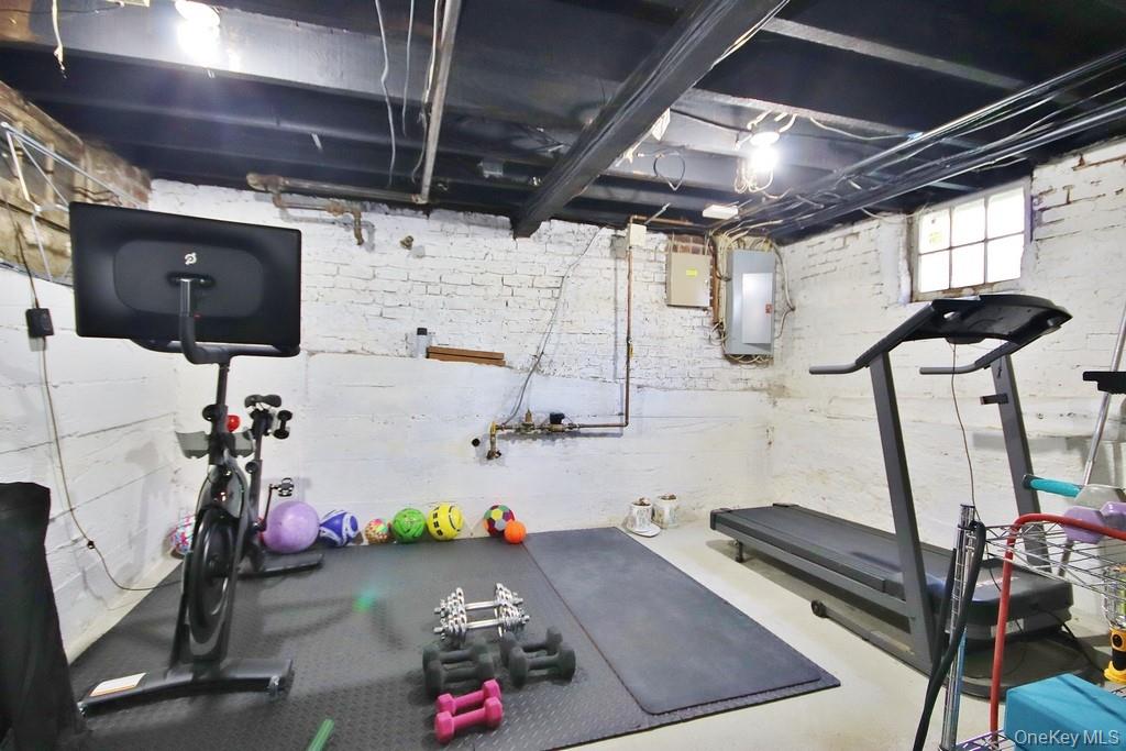 22 High Street Garnerville, NY 10923 - Photo 29 of 49 a room with gym equipment and a flat screen tv