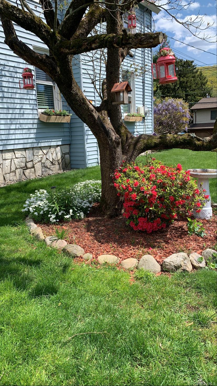 22 High Street Garnerville, NY 10923 - Photo 48 of 49 a front view of a house with a yard and potted plants