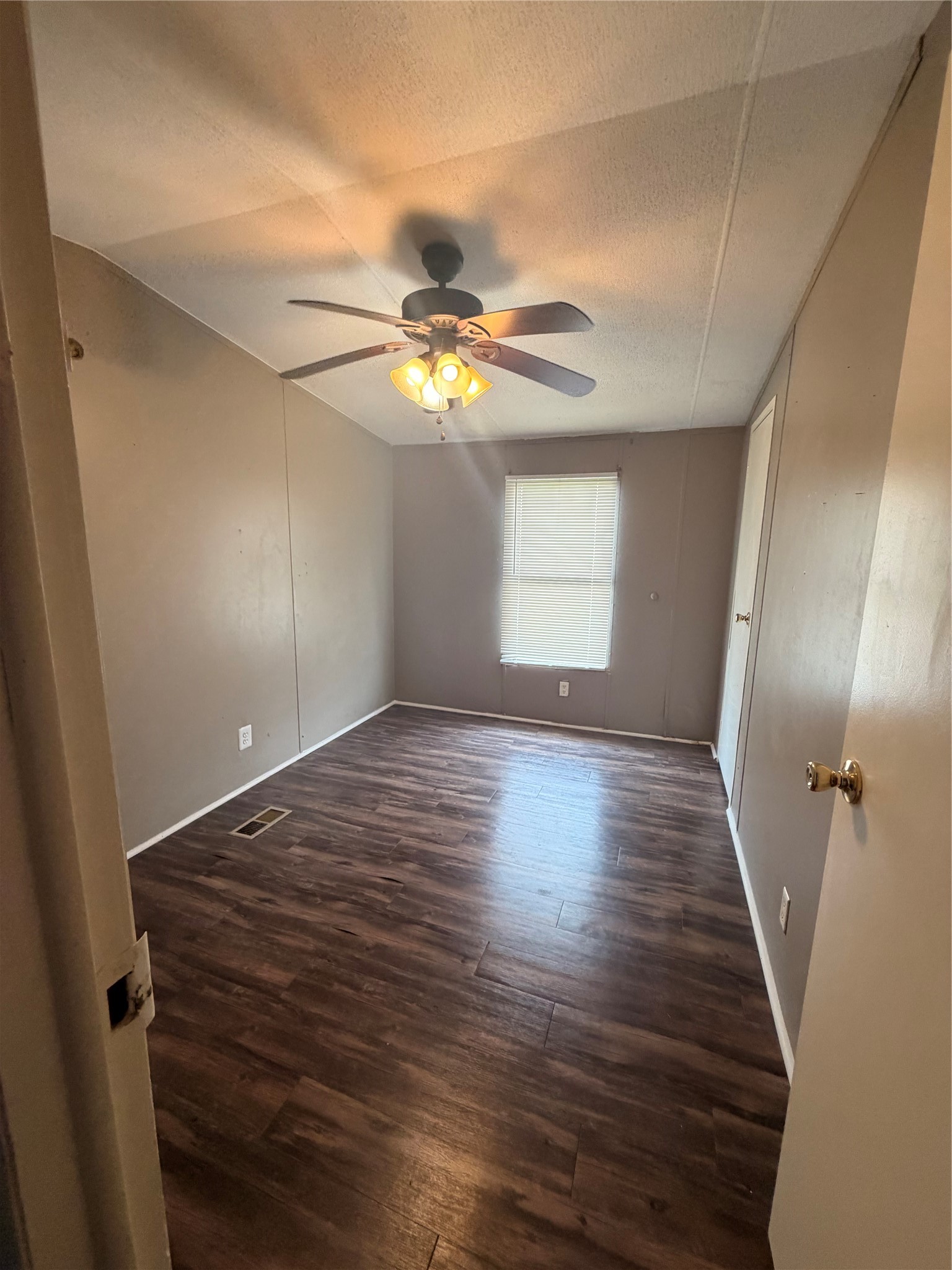 2021 North Battlebell Road, Unit 40 Highlands, TX 77562 - Photo 11 of 19 en empty room with wooden floor and window