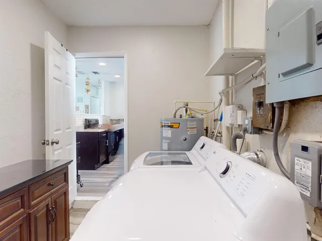 a large bedroom with a bed and large mirror