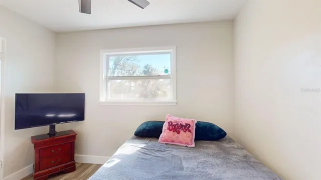 a bedroom with a bed and window