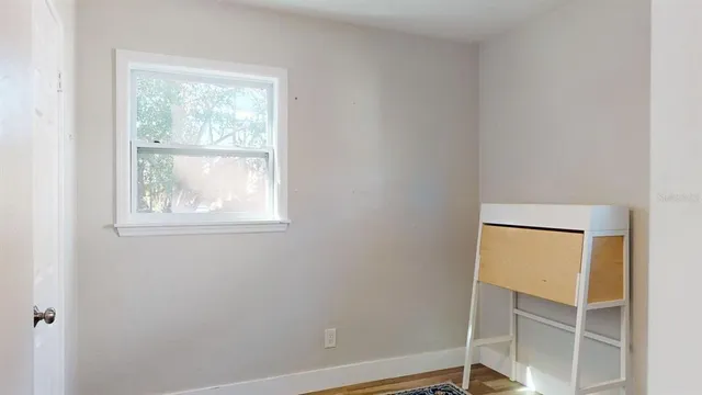 a backyard of a house with outdoor seating and trees