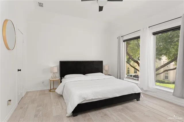 a bedroom with a large bed and a window
