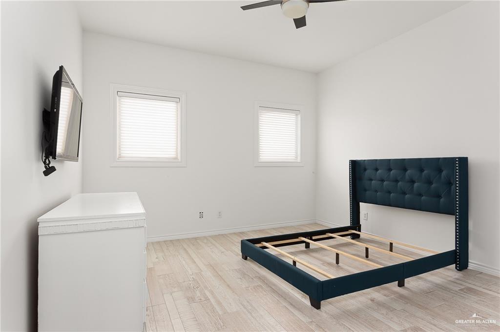 3100 South 2nd Street, Unit 29 McAllen, TX 78503 - Photo 14 of 23 a living room with a couch a rug and a flat screen tv