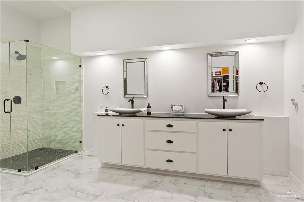 3100 South 2nd Street, Unit 29 McAllen, TX 78503 - Photo 17 of 23 a bathroom with a granite countertop sink mirror and shower